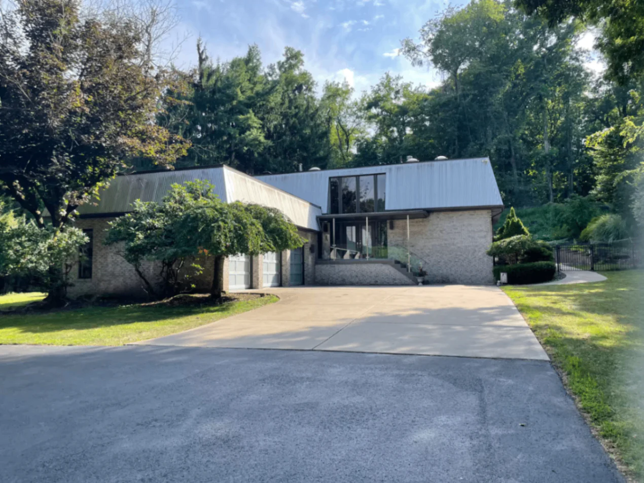 Posh Pittsburgh exterior and driveway surrounded by trees