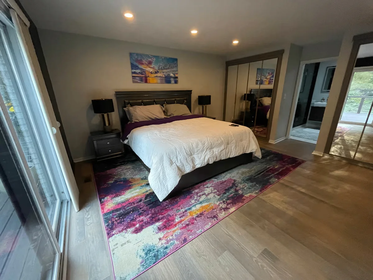 Be the Sky bedroom with colorful artwork, mirrored closet doors, and terrace view.
