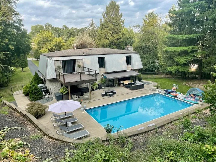 Posh Pittsburgh house with a pool surrounded by emerald forest